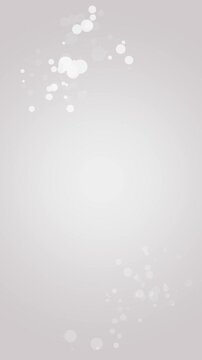 またたく光の縦長アニメーション。白とグレーの背景。