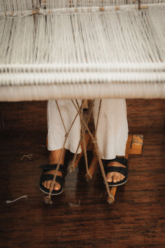 Chumey, Bhutan - 23 September 2025: View of a weaver's feet resting on the loom pedals, threads suspended above, creating a scene of focused artistry.