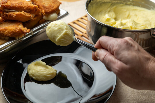 Cheese in breadcrumbs with smashed potato