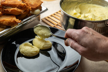 Cheese in breadcrumbs with smashed potato