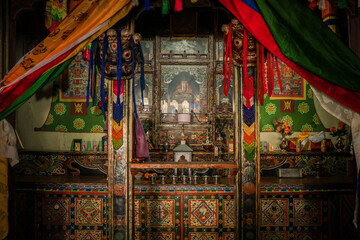 Ha, Bhutan - 26 September 2025: View of an ornate altar adorned with vibrant textiles and intricate carvings, creating a sacred space filled with rich colors and textures.