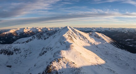 Majestic snow-capped mountain peak under a clear blue sky.