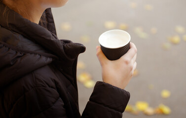 Cup of cappuccino in female hand