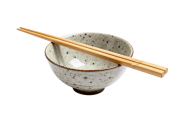 A ceramic bowl with chopsticks placed on it for eating