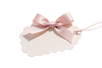 A delicate pink ribbon tied on a scalloped tag for gift decoration