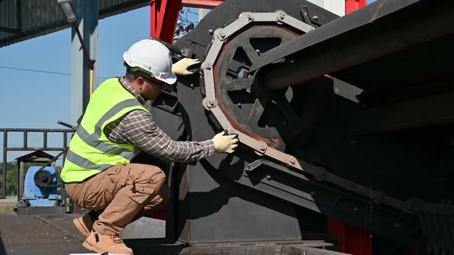 Technical Worker Inspecting Mechanical System in Industrial Environment