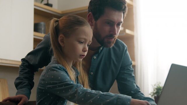 Family at home kitchen concentrates confused little daughter kid child girl schoolgirl e-learning lesson education hard difficult task need help with laptop writing homework ask father for helping