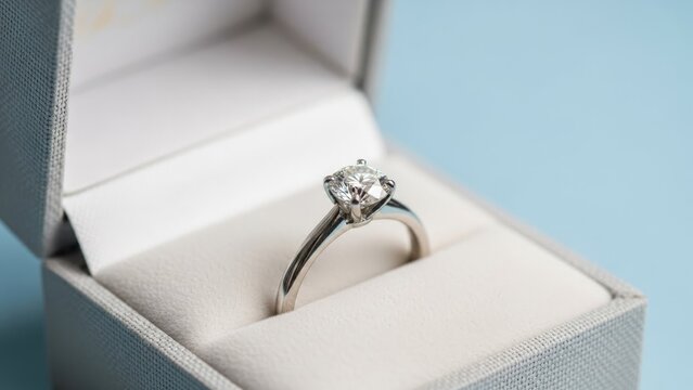 Elegant diamond engagement ring in light blue jewelry box romantic proposal gift for wedding anniversary and valentines celebration - Powered by Adobe