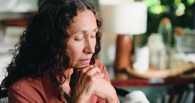 Thinking, sad and mature woman in home with loneliness, stress or remember past with regret. Reflection, depression and person in living room with anxiety for mental health, nostalgia and flashback