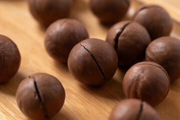 Macadamia nuts on wooden background, Close up