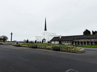 Fototapeta premium Knock Ireland town square with church spire and flower gardens in a peaceful setting