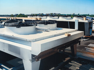 Industrial rooftop air conditioning units against a clear blue sky