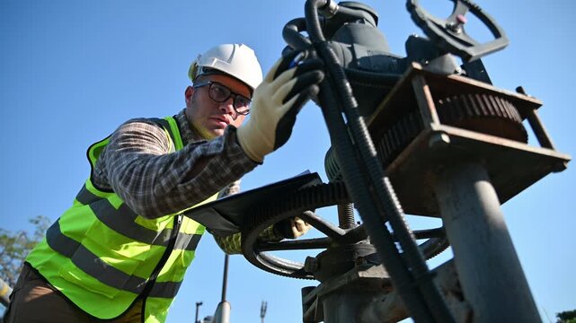 Engineer Conducting Equipment Check During Industrial Maintenance