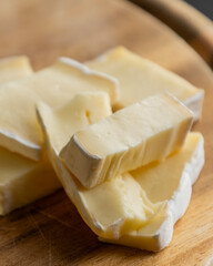 Brie Cheese Slices on Wooden Cutting Board – Close Up
