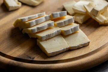 Brie Cheese Slices on Wooden Cutting Board – Close Up