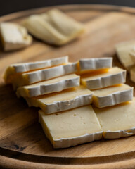 Brie Cheese Slices on Wooden Cutting Board – Close Up