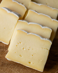 Brie Cheese Slices on Wooden Cutting Board – Close Up