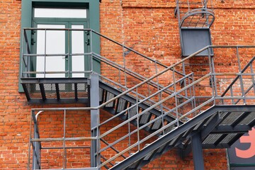 Fire escape stairs on brick wall background, fire escape stairs on brick wall