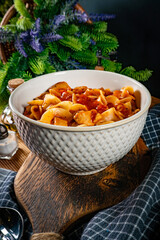 Pieces of chicken with noodle in tomato and herb sauce.