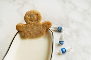 Gingerbread man bathes in a tub of milk
