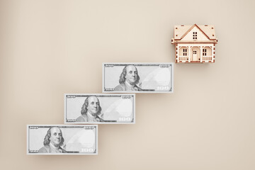 Financial steps toward home ownership with money stairs and house model
