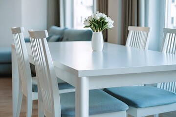 Modern white dining table with chairs in a living room setting