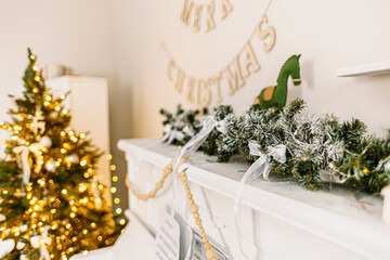 Warm Christmas interior with glowing lights, frosted garland, and festive holiday decor.