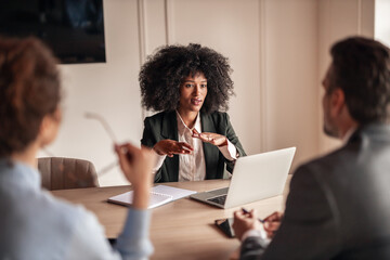 Professional Woman Leading a Business Meeting in a Modern Office Setting