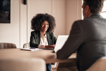 Smiling Professional Women Collaborating in a Modern Office Setting