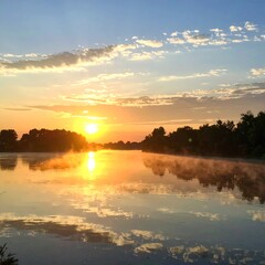 Obraz premium Sunrise over a calm river