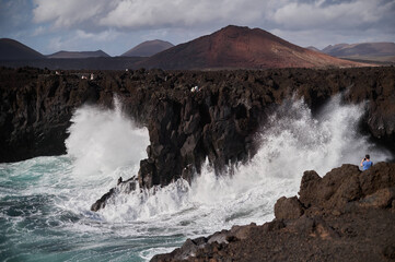 Dramatic volcanic cliffs and sea caves of Los Hervideros, where ocean waves crash and churn spectacularly, Lanzarote, Spain