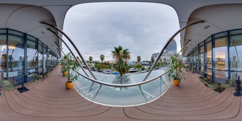 Outdoor Cafe Terrace 360 Panorama on Sherif Khimshiashvili Street. Modern dining area with potted palm trees and view of the street on a cloudy day.