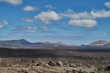 Dramatic volcanic landscape and red earth of Timanfaya National Park, an otherworldly scenic tourist attraction, Lanzarote, Spain