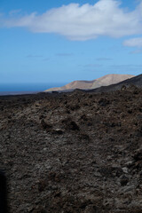 Dramatic volcanic landscape and red earth of Timanfaya National Park, an otherworldly scenic tourist attraction, Lanzarote, Spain