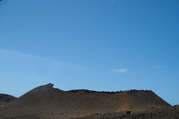 Dramatic volcanic landscape and red earth of Timanfaya National Park, an otherworldly scenic tourist attraction, Lanzarote, Spain