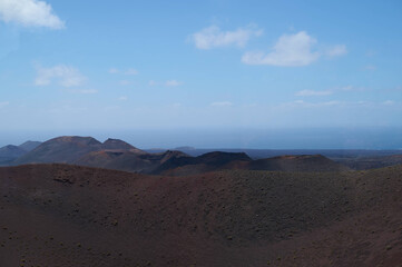 Dramatic volcanic landscape and red earth of Timanfaya National Park, an otherworldly scenic tourist attraction, Lanzarote, Spain