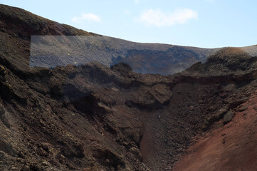 Dramatic volcanic landscape and red earth of Timanfaya National Park, an otherworldly scenic tourist attraction, Lanzarote, Spain