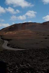 Dramatic volcanic landscape and red earth of Timanfaya National Park, an otherworldly scenic tourist attraction, Lanzarote, Spain