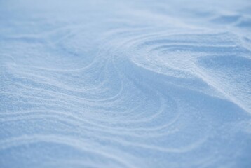 Wind-patterned snow texture in gentle blue tones