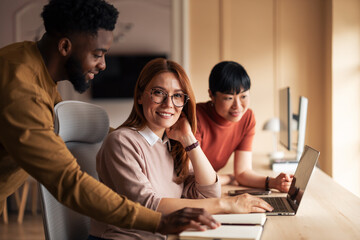 Team Collaborating in Modern Office Environment on Creative Project