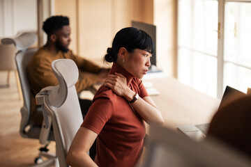 Office Worker Experiencing Neck Pain While Seated at an Ergonomic Desk