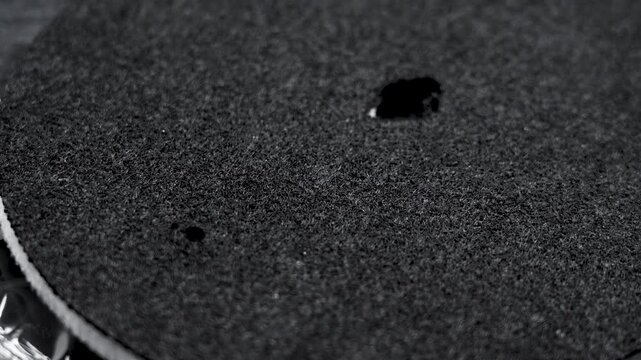 Black texture of a clean industrial filter on transparent cellophane packaging. Water purification spare part