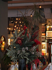Festive interior decor with decorated Christmas trees in warm public setting.