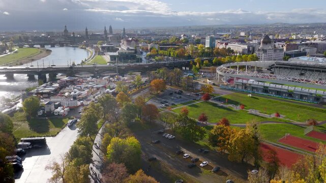 Aerial view of the freshly renovated Heinz Steyer Stadium in Dresden on a sunny day. The shot shows the sports facilities (running tracks, turf) as well as the Elbe River and the historical Dresden ci