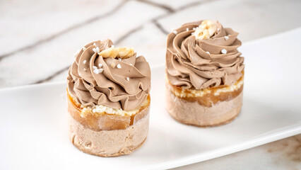 Mini caramel mousse desserts with cream swirl