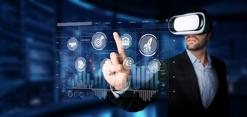 A business professional utilizes virtual reality technology to interact with data analytics, enhancing marketing strategies and improving market targeting within a modern workspace. XDMCP