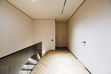 Calm passage featuring soft illumination and stylish flooring