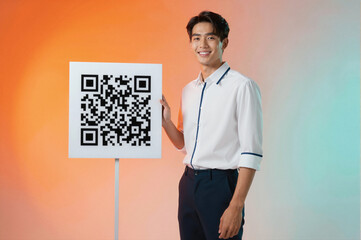 A smiling man in a white shirt holding a QR code sign against an orange and blue gradient background.