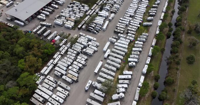 New camping trailers parked for sale on RV dealer parking lot in Ft. Myers, Florida.