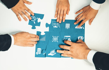 A diverse team engages in a collaborative data analysis session, using puzzle pieces to symbolize the integration of insights and strategies for effective business solutions. Amity